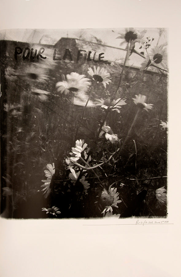Robert Frank's Flower Is consists of three bodies of work. It begins with photographs taken in Paris of flowers, flower sellers, and chance encounters on the street, continues in a car factory in Detroit, and ends with polaroids made in Mabou Mines, Nova Scotia.