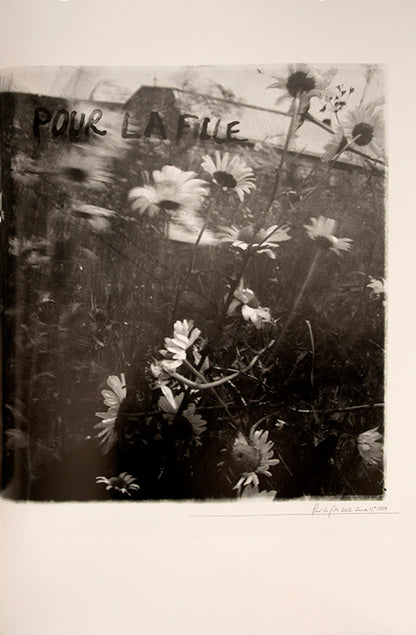 Robert Frank's Flower Is consists of three bodies of work. It begins with photographs taken in Paris of flowers, flower sellers, and chance encounters on the street, continues in a car factory in Detroit, and ends with polaroids made in Mabou Mines, Nova Scotia.