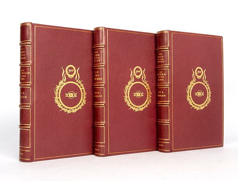 First editions of  the three volumes of The Lord of the Rings by J.R.R. Tolkien bound by Sangorski & Sutcliffe with the Eye of Sauron on the front board of each in gilt