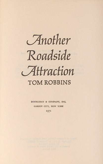 First edition of Another Roadside Attraction by Tom Robbins, signed by the author.