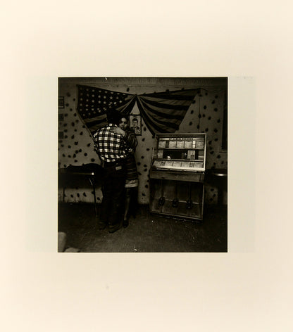 Bruce Davidson regularly visited East Harlem with a view camera and tripod with which he photographed the residents of a city block on East 100th Street between First and Second Avenues in New York. Davidson chose this block because, at the time, it had a reputation as being one of the worst in the city.