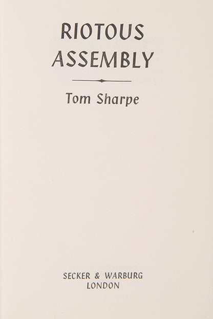 A very good first edition of Riotous Assembly, the satirical novel that made Tom Sharpe famous.