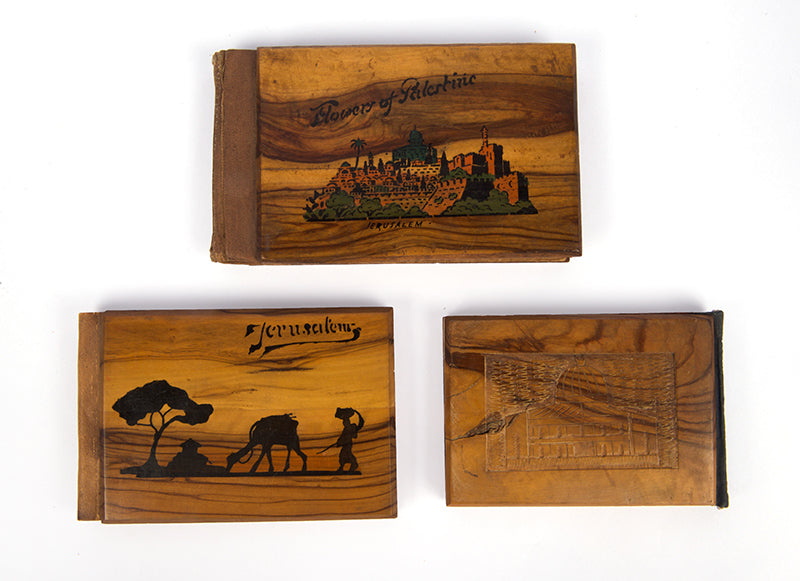 Early 20th-century souvenirs from Jerusalem, containing local dried flowers and colour-lithograthed views of the Holy Land.