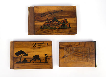 Early 20th-century souvenirs from Jerusalem, containing local dried flowers and colour-lithograthed views of the Holy Land.