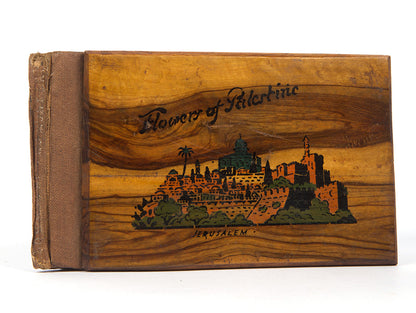 Early 20th-century souvenirs from Jerusalem, containing local dried flowers and colour-lithograthed views of the Holy Land.