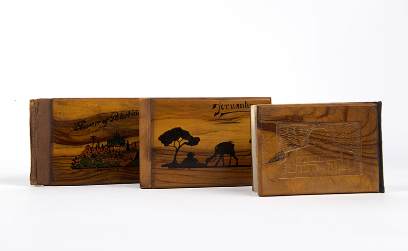 Early 20th-century souvenirs from Jerusalem, containing local dried flowers and colour-lithograthed views of the Holy Land.