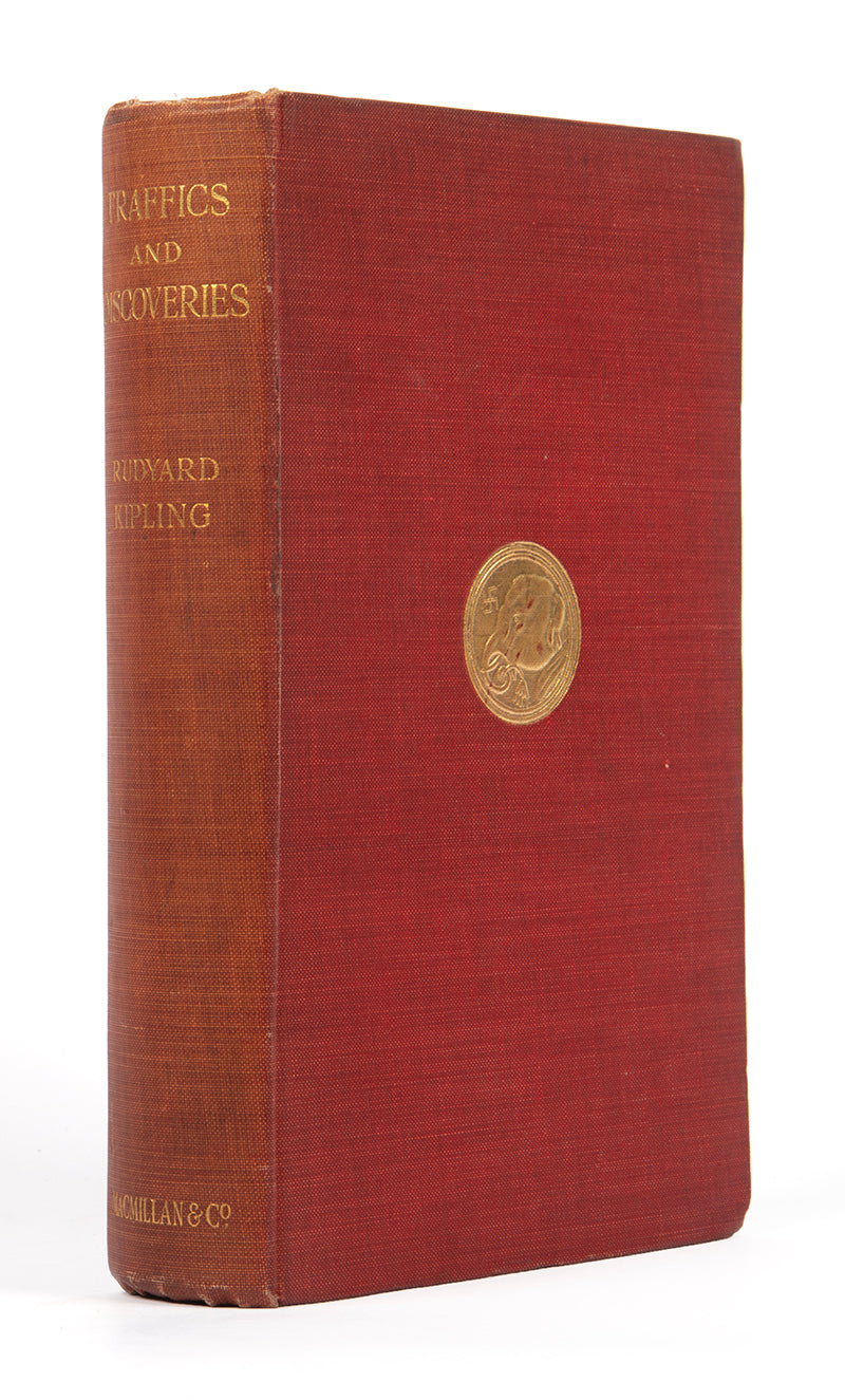 First edition copy of Rudyard Kipling's Traffics and Discoveries a collection of short stories in the publisher's original red cloth with a gilt-blocked medallion to upper panel