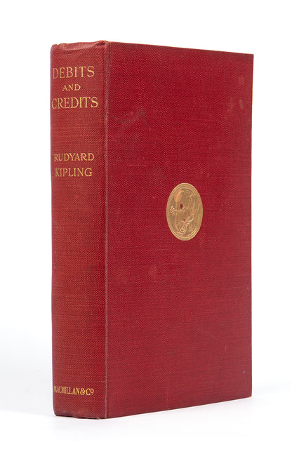first edition copy of rudyard kipling's debits and credits with publisher's original red cloth and gilt medallion to upper panel consisting of short stories and poems