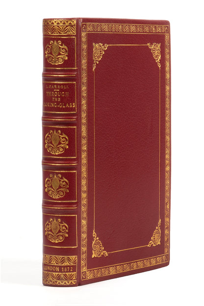 A handsomely bound edition of Through the looking glass, by Lewis Carroll, in red leather and gilt, First edition, second issue, 1872, thirteenth thousand