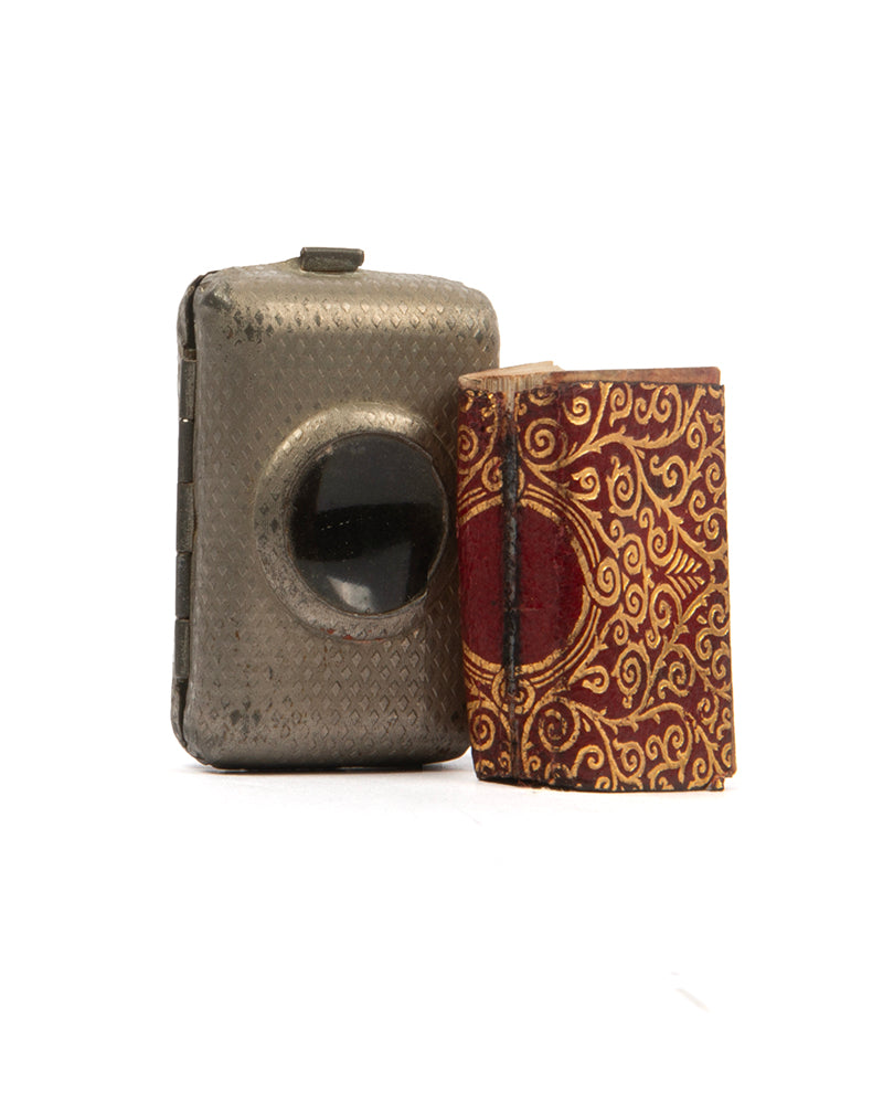 early steinbrener miniature quran with metal case  incorporating magnifying glass