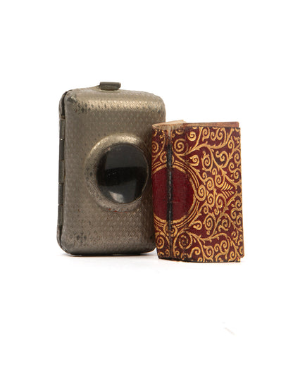early steinbrener miniature quran with metal case  incorporating magnifying glass