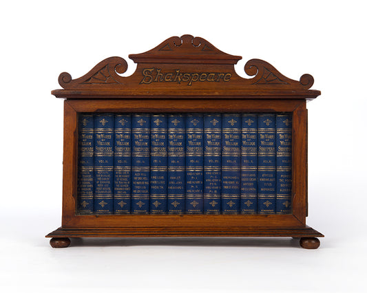 A charming pocket book set of Shakespeare's complete works, housed in the original glazed wooden cabinet.