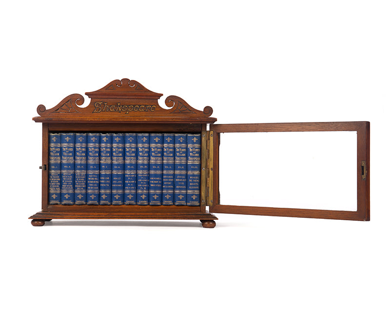 A charming pocket book set of Shakespeare's complete works, housed in the original glazed wooden cabinet.