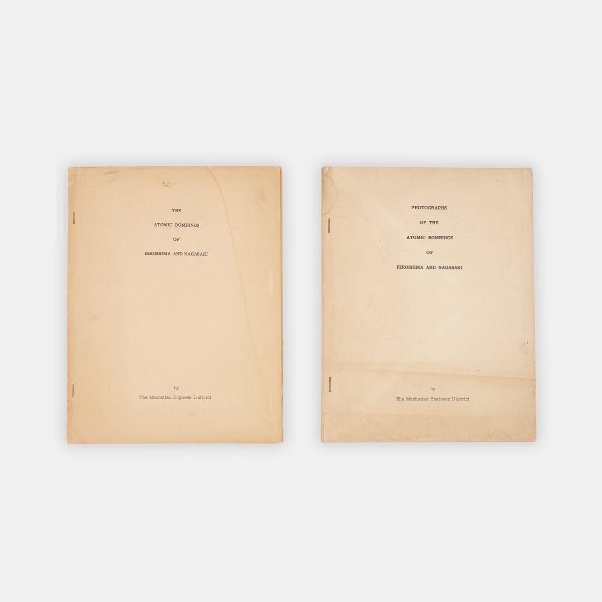 First edition, the complete set with both text and photo volumes, of this important, early scientific report on the atomic bombings of Hiroshima and Nagasaki by representatives f the Manhattan Project.