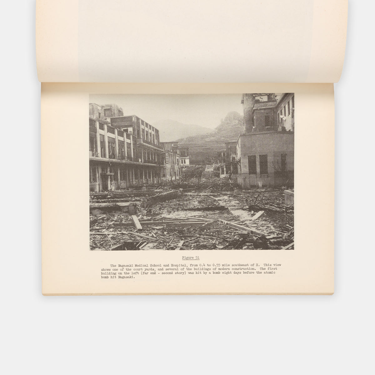 First edition, the complete set with both text and photo volumes, of this important, early scientific report on the atomic bombings of Hiroshima and Nagasaki by representatives f the Manhattan Project.