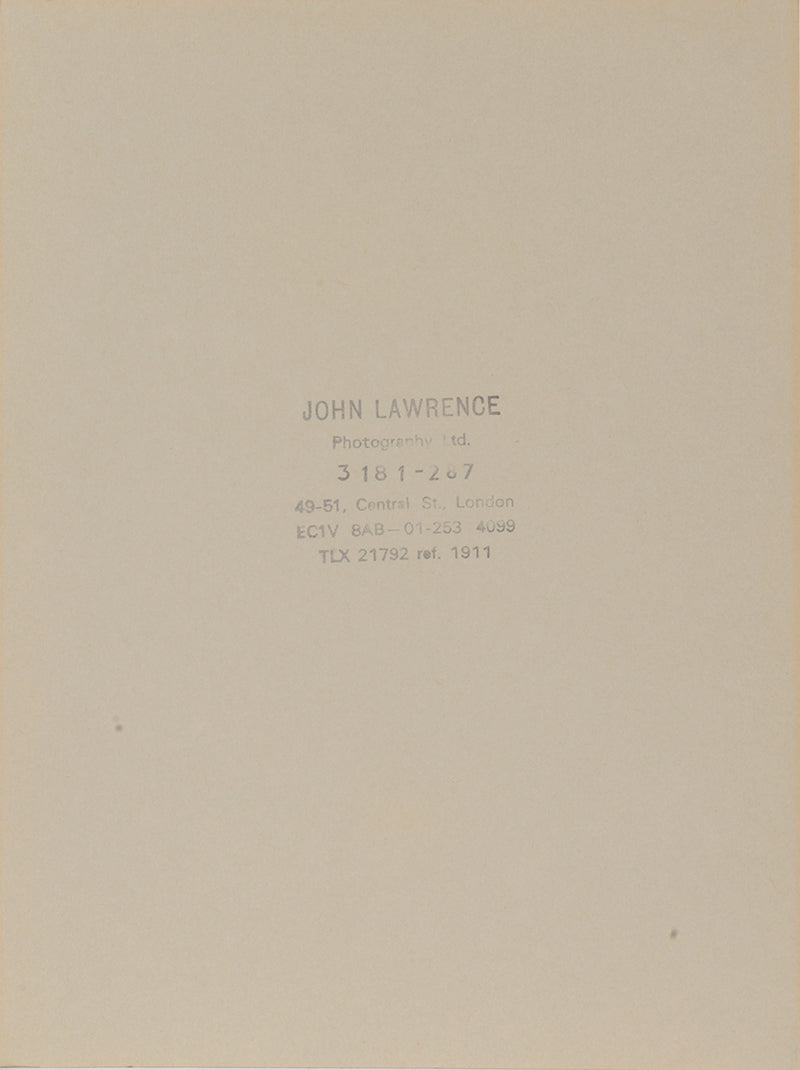 Two signed three-quater length photographic portraits by John Lawrence of HM Queen Elizabeth II and Prince Philip, dated 1986 in original frames by Longmire