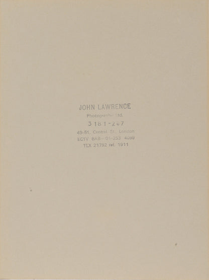 Two signed three-quater length photographic portraits by John Lawrence of HM Queen Elizabeth II and Prince Philip, dated 1986 in original frames by Longmire