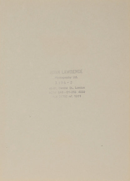 Two signed three-quater length photographic portraits by John Lawrence of HM Queen Elizabeth II and Prince Philip, dated 1986 in original frames by Longmire