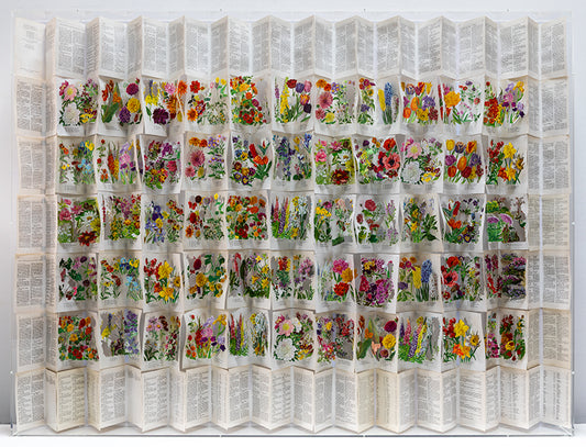 A cut book construction in an acrylic case by Jack Milroy, titled The Librarians Cottage Garden, 2026. 