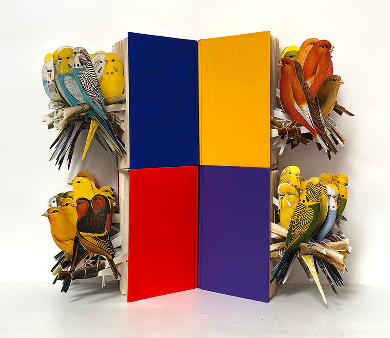 A cut book construction in an acrylic case by Jack Milroy, titled The Critics. 
