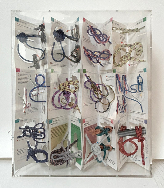 A cut book construction in an acrylic case by Jack Milroy, titled Not Knots. 
