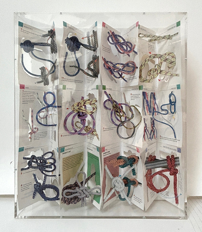 A cut book construction in an acrylic case by Jack Milroy, titled Not Knots. 