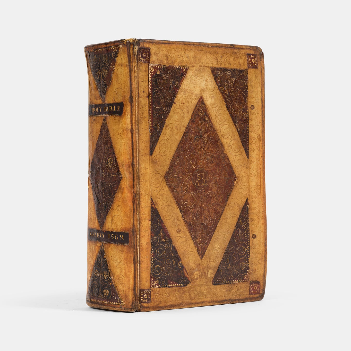 A remarkable copy of the second quarto edition of the Geneva Bible, complete with hand-coloured woodcut illustrations and 5 maps, and bound in seventeenth-century vellum gilt onlaid in red morocco