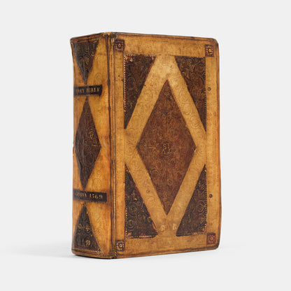 A remarkable copy of the second quarto edition of the Geneva Bible, complete with hand-coloured woodcut illustrations and 5 maps, and bound in seventeenth-century vellum gilt onlaid in red morocco