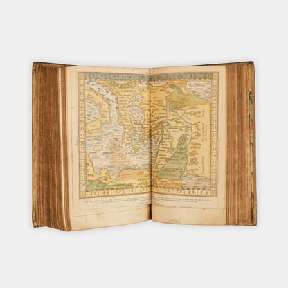 A remarkable copy of the second quarto edition of the Geneva Bible, complete with hand-coloured woodcut illustrations and 5 maps, and bound in seventeenth-century vellum gilt onlaid in red morocco