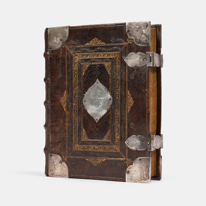 An impressive mid-seventeenth century King James Bible, splendidly preserved in an English Restoration binding of gilt panelled blackmorocco with silver furniture including the original working clasps