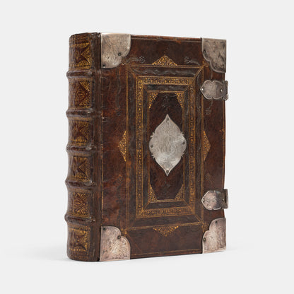 An impressive mid-seventeenth century King James Bible, splendidly preserved in an English Restoration binding of gilt panelled blackmorocco with silver furniture including the original working clasps