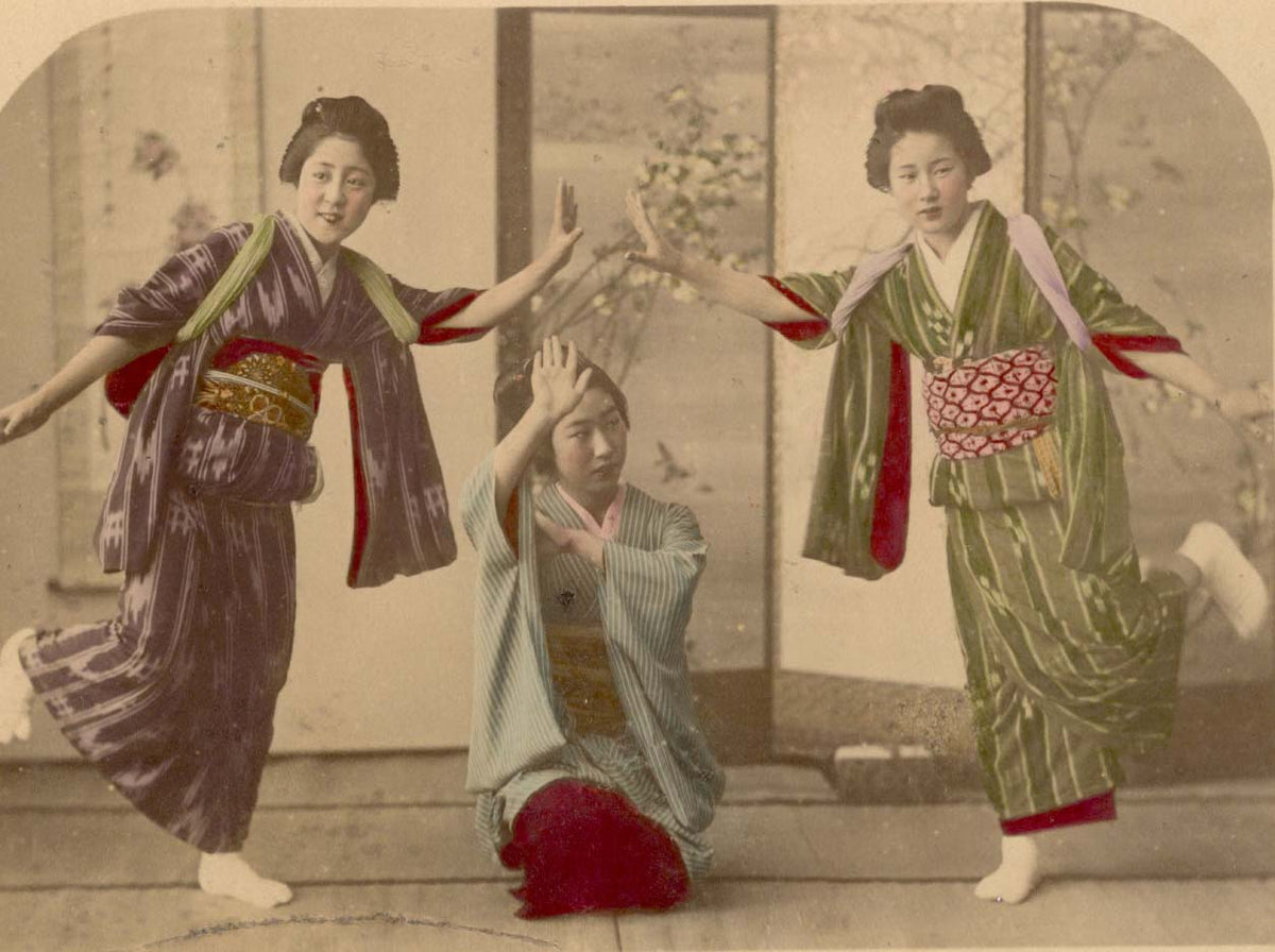 An albumen print showing a group of three maiko (apprentice geisha) dancing, circa 1880s