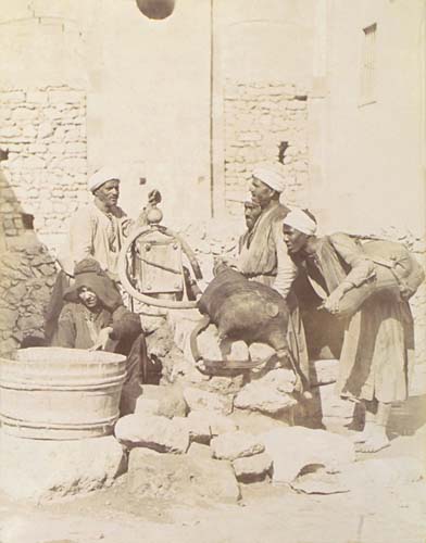 [Water carriers at a well].