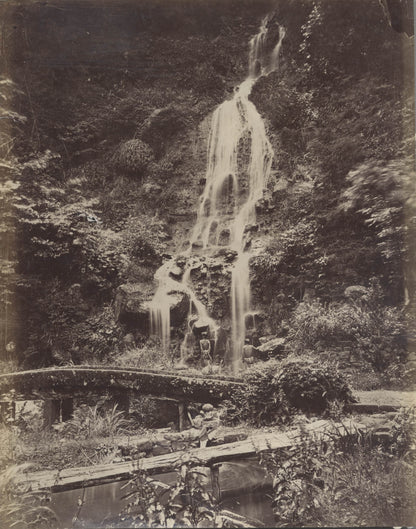 Man Standing Under Waterfall