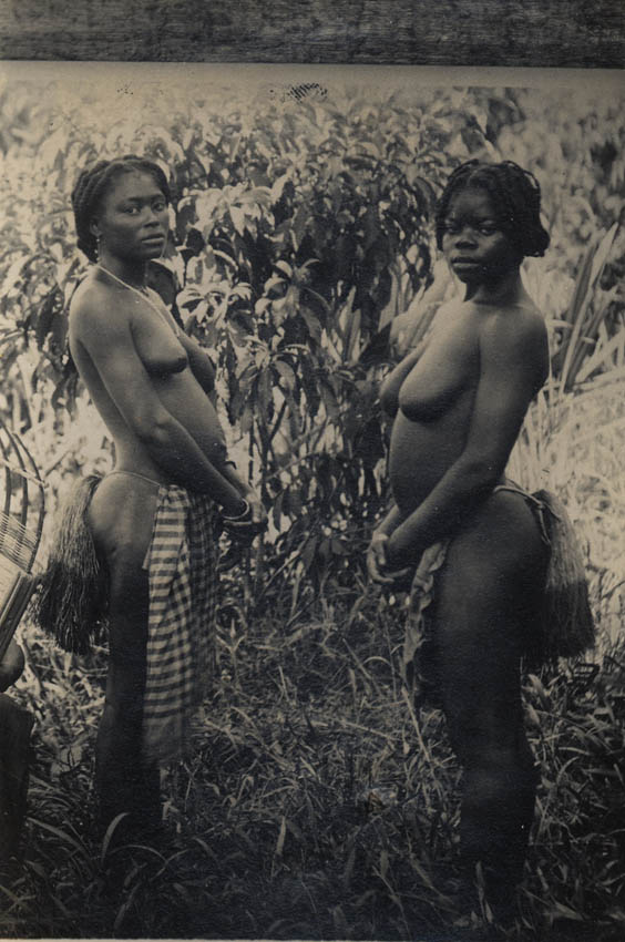 [Two bare-chested African girls].
