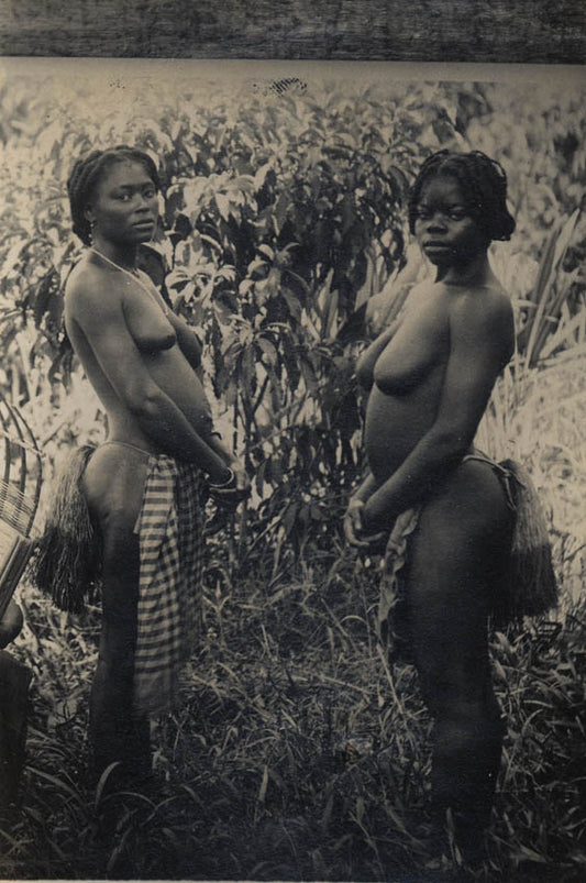 [Two bare-chested African girls].